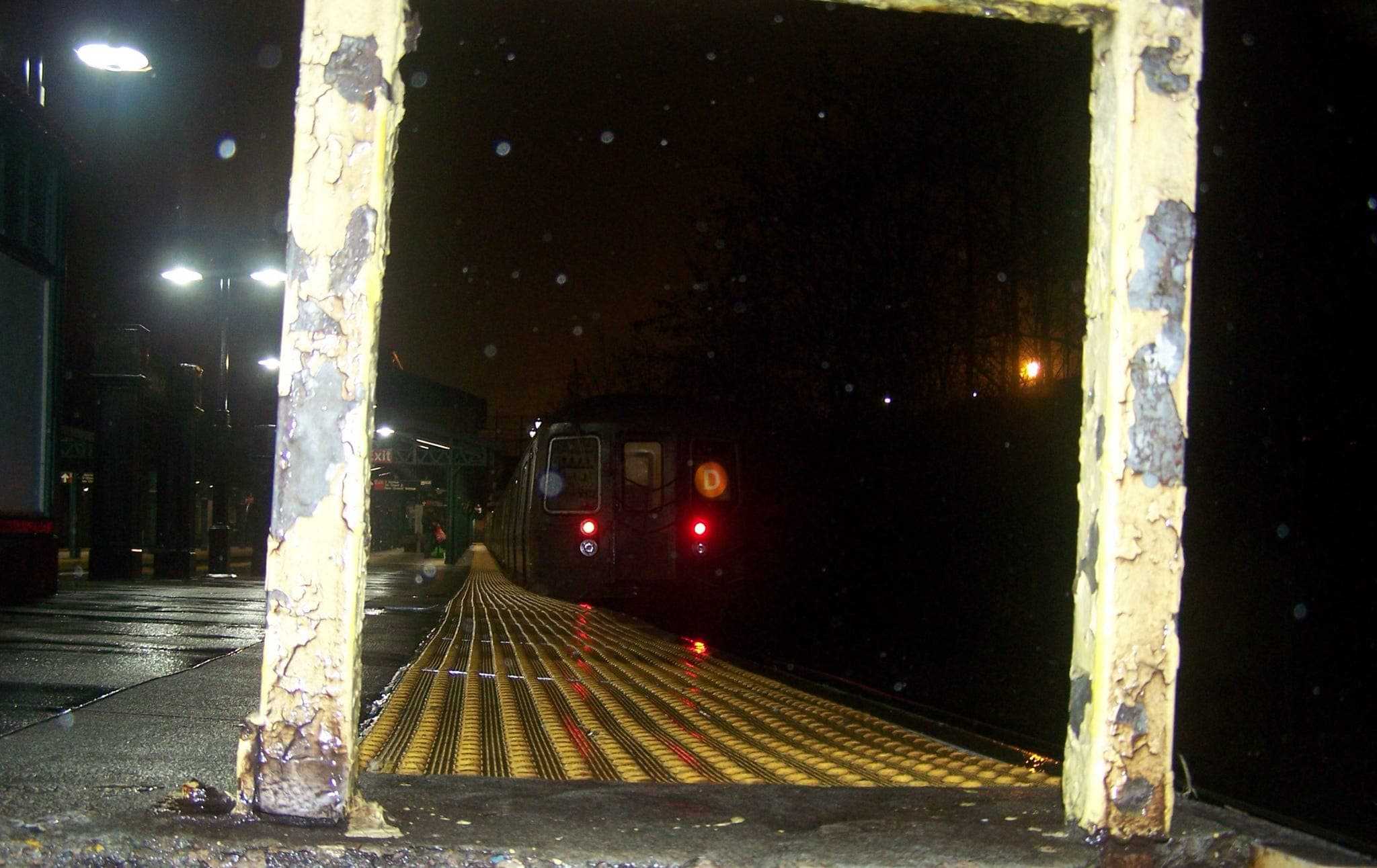 An R68 D train departing the station late at night as we prepare to enter the lower level
